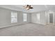 Spacious main bedroom with ceiling fan and carpet at 7218 Mossy Creek Ln, Hanahan, SC 29410