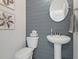 Powder room with pedestal sink and gray shiplap accent wall at 768 Maynard Ln, Summerville, SC 29486