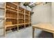 Unfinished basement with built-in shelving and workbench at 9681 Two Pines Rd, McClellanville, SC 29458