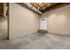 Unfinished basement area with concrete floor and door at 9681 Two Pines Rd, McClellanville, SC 29458