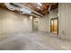 Unfinished basement with high ceilings, concrete floor, and elevator at 9681 Two Pines Rd, McClellanville, SC 29458