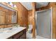 Bathroom with shower, toilet and wood paneled walls at 9681 Two Pines Rd, McClellanville, SC 29458