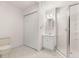 Basement bathroom with shower, toilet, vanity, and double doors to closet at 9681 Two Pines Rd, McClellanville, SC 29458