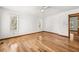 Hardwood floor bedroom with two windows and door to bathroom at 9681 Two Pines Rd, McClellanville, SC 29458