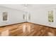 Spacious bedroom with hardwood floors and multiple windows at 9681 Two Pines Rd, McClellanville, SC 29458