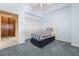 Small bedroom with light blue walls, twin bed, and double doors to closet at 9681 Two Pines Rd, McClellanville, SC 29458