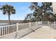 Spacious deck with white railings offering scenic waterfront views at 9681 Two Pines Rd, McClellanville, SC 29458