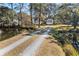 Long private driveway leading to a waterfront home through lush greenery at 9681 Two Pines Rd, McClellanville, SC 29458
