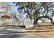 Elevated home with white stairs leading to deck, offering marsh views at 9681 Two Pines Rd, McClellanville, SC 29458
