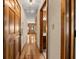Hardwood floor hallway with wood doors and access to bathroom and other rooms at 9681 Two Pines Rd, McClellanville, SC 29458