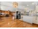 Open concept kitchen and living room with hardwood floors and island at 9681 Two Pines Rd, McClellanville, SC 29458