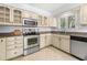 Kitchen with stainless steel appliances and light cream cabinets at 9681 Two Pines Rd, McClellanville, SC 29458