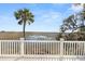 Deck overlooks tranquil marsh landscape with boardwalk in distance at 9681 Two Pines Rd, McClellanville, SC 29458