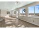 Sunroom with water views, light wood walls, and vinyl flooring at 9681 Two Pines Rd, McClellanville, SC 29458