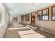 Bright sunroom with light wood walls, vinyl flooring and water views at 9681 Two Pines Rd, McClellanville, SC 29458