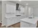 Sleek white kitchen with stainless steel appliances, island, and white countertops at 1052 Old Cypress Run, Hanahan, SC 29410