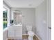 Clean bathroom with white vanity, shower, and wood-look flooring at 1106 Old Highway 6, Cross, SC 29436