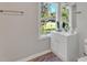 Bathroom with white vanity, window, and wood-look flooring at 1106 Old Highway 6, Cross, SC 29436