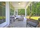 Covered back porch with seating area and view of the backyard at 117 Crosscut Ln, Summerville, SC 29486
