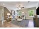 Bright bonus room featuring a comfortable sectional sofa and large windows at 117 Crosscut Ln, Summerville, SC 29486