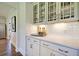 Butlers pantry with white cabinets, quartz countertops, and glass-front cabinets at 117 Crosscut Ln, Summerville, SC 29486