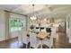 Bright dining room with hardwood floors, a farmhouse table, and kitchen view at 117 Crosscut Ln, Summerville, SC 29486