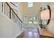 Bright two-story foyer with hardwood floors, featuring a staircase and front door at 117 Crosscut Ln, Summerville, SC 29486