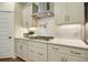 Kitchen features gas cooktop, white cabinets, and white subway tile backsplash at 117 Crosscut Ln, Summerville, SC 29486