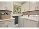 Bright laundry room with white cabinets and quartz countertops at 117 Crosscut Ln, Summerville, SC 29486