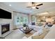 Spacious living room boasts a cozy fireplace, large windows, and comfortable seating area with plush sofas and pillows at 117 Crosscut Ln, Summerville, SC 29486
