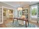 Bright home office with a view of the kitchen and features a wood desk and stylish rug at 117 Crosscut Ln, Summerville, SC 29486