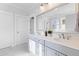 Modern bathroom with double vanity, marble floors, and a large mirror at 1213 Captain Rivers Dr, Charleston, SC 29412