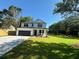 Inviting white farmhouse with a black roof, front porch, and driveway at 1289 Hamlin Rd, Mount Pleasant, SC 29466