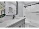 Clean bathroom with a quartz countertop and a frameless shower at 13 Edgewater Aly, Isle of Palms, SC 29451