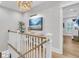 Upstairs hallway with white railings, light walls, and a coastal art piece at 13 Edgewater Aly, Isle of Palms, SC 29451