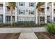 Apartment building exterior with palm trees and walkway at 1300 Park West Blvd # 420, Mount Pleasant, SC 29466