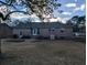 Exterior view of a brick ranch-style home with a gray roof and a large backyard at 135 Tall Pines Rd, Ladson, SC 29456