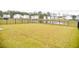 Large backyard with pond view and black fence at 156 Surfbird Rd, Summerville, SC 29486