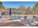 Relaxing community pool area with lounge chairs, umbrellas, and landscaping at 1600 Long Grove Dr # 914, Mount Pleasant, SC 29466