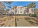 Attractive building exterior with balconies, lush landscaping, and ample parking at 1600 Long Grove Dr # 914, Mount Pleasant, SC 29466
