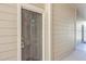 Close-up of apartment front door with keypad lock and light beige siding at 1600 Long Grove Dr # 914, Mount Pleasant, SC 29466