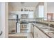 Kitchen featuring stainless steel appliances, white cabinets, and granite countertops at 1600 Long Grove Dr # 914, Mount Pleasant, SC 29466