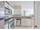 Updated kitchen with stainless steel appliances, granite countertops, and white cabinetry at 1600 Long Grove Dr # 914, Mount Pleasant, SC 29466
