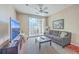 Living room with comfy seating, large TV, and sliding glass doors leading to a balcony at 1600 Long Grove Dr # 914, Mount Pleasant, SC 29466