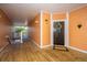 Apartment entryway with peach walls, wood floors, and a black door at 1631 Chatelain Way, Mount Pleasant, SC 29464