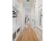 Bright hallway with hardwood floors, built-in storage, and access to a side entrance at 1767 Pierce St, Charleston, SC 29492