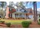 Brick home with a wrap-around porch and landscaped yard at 201 Castle Harbor Dr, Summerville, SC 29483