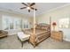 Bedroom featuring wooden four-poster bed, shuttered windows, and plush carpet at 2032 Amenity Park Dr, Mount Pleasant, SC 29466