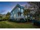 Charming coastal home exterior with front porch at twilight at 2032 Amenity Park Dr, Mount Pleasant, SC 29466