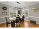 Dining area with wooden table, black chairs, and large windows at 2054 Briar Bend Rd, Ridgeville, SC 29472